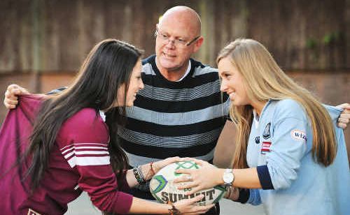 St John’s College principal Chris Gold tries to keep Year 12 students and friends Kelly Edwards (left) and Bianca McMahon apart. The girls have a long-running State of Origin rivalry. Mr Gold is a New South Welshman, but in order to keep the peace remains impartial.